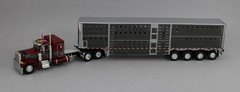DCP 1:64 *RED* Peterbilt 379 48″ Flattop w/Quad-Axle Wilson Livestock Trailer