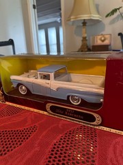 1:18 scale diecast replica of a 1957 Ford Ranchero in blue and white by Road Sig