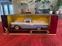 1:18 scale diecast replica of a 1957 Ford Ranchero in blue and white by Road Sig