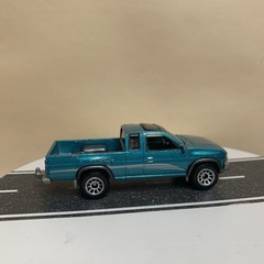 2022 Matchbox 1995 Nissan Hardbody D21 Green-Blue Teal Metallic w/Graphic 1:64